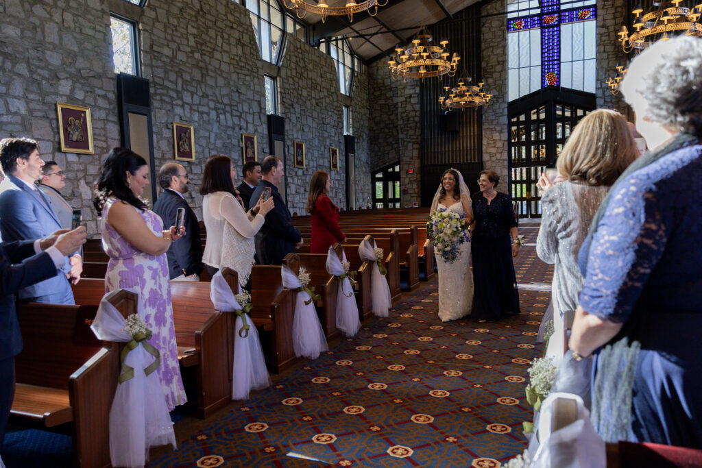 The bride and her mother walking down the aisle.