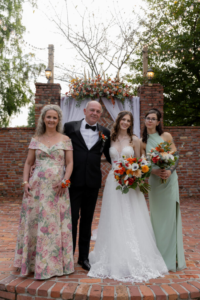 The bride and her family in a family portrait.
