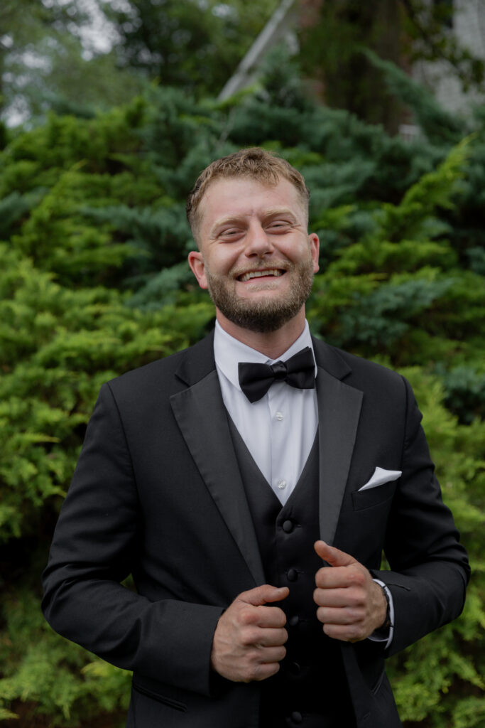 A self portrait of the groom smiling at the camera.