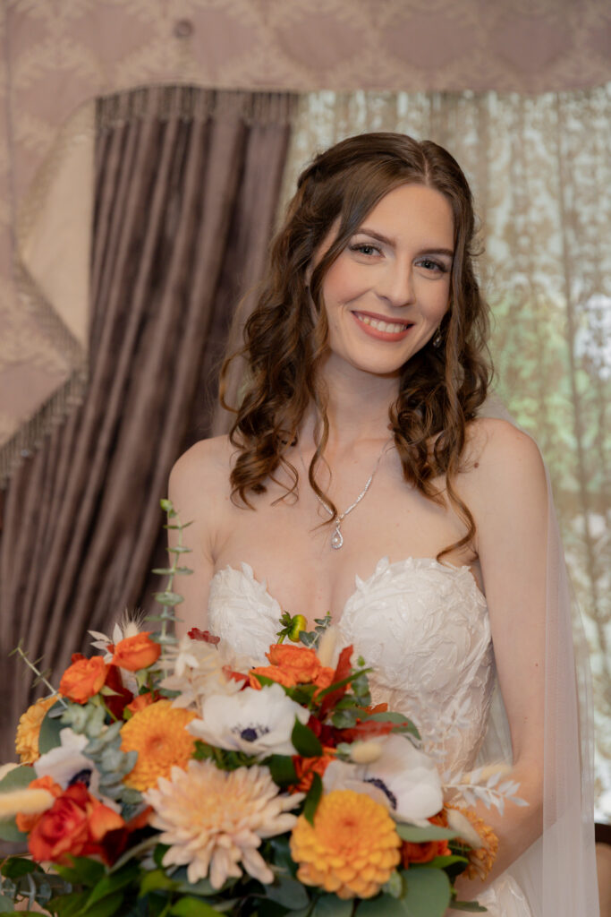 A portrait photo of the bride holding her bouquet.