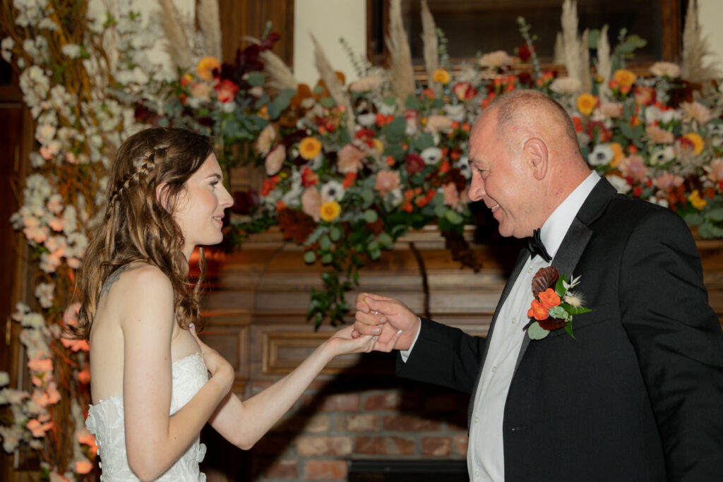 A candid moment between the bride and her dad before their first dance during the wedding reception.